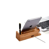 Wooden desk organizer with tablet, laptop, and pen on a white background