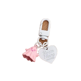 Keychain with pink shell and heart-shaped tag on a white background