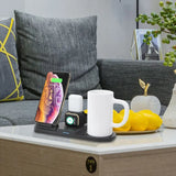 Wireless charging station on a coffee table with phone, watch, and mug
