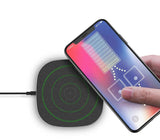Wireless charging pad with a smartphone on a white background