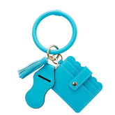Turquoise keychain with wallet and tassel on a white background