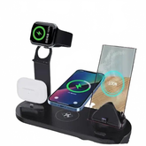 Multi-device wireless charging stand on a wooden surface with a green background