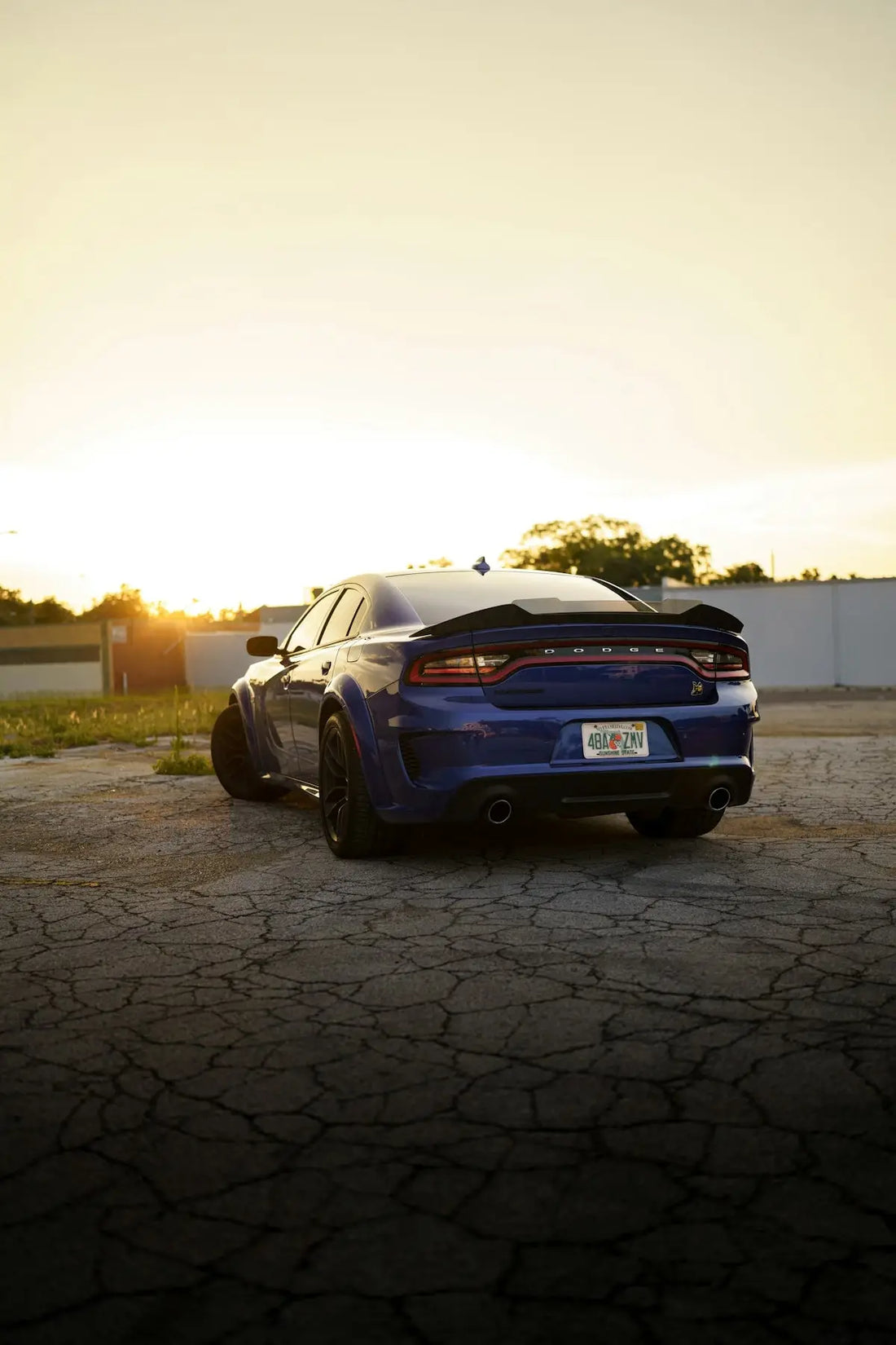 a blue car parked on a brick road