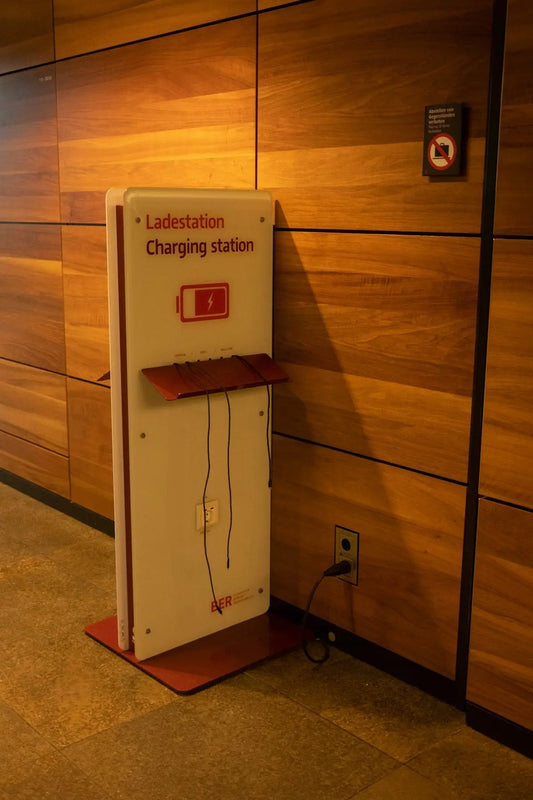 a red and white charging station next to a wooden wall