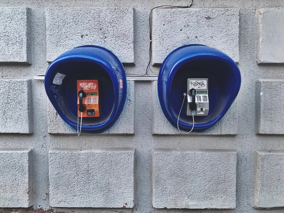 two blue telephone booths on wall