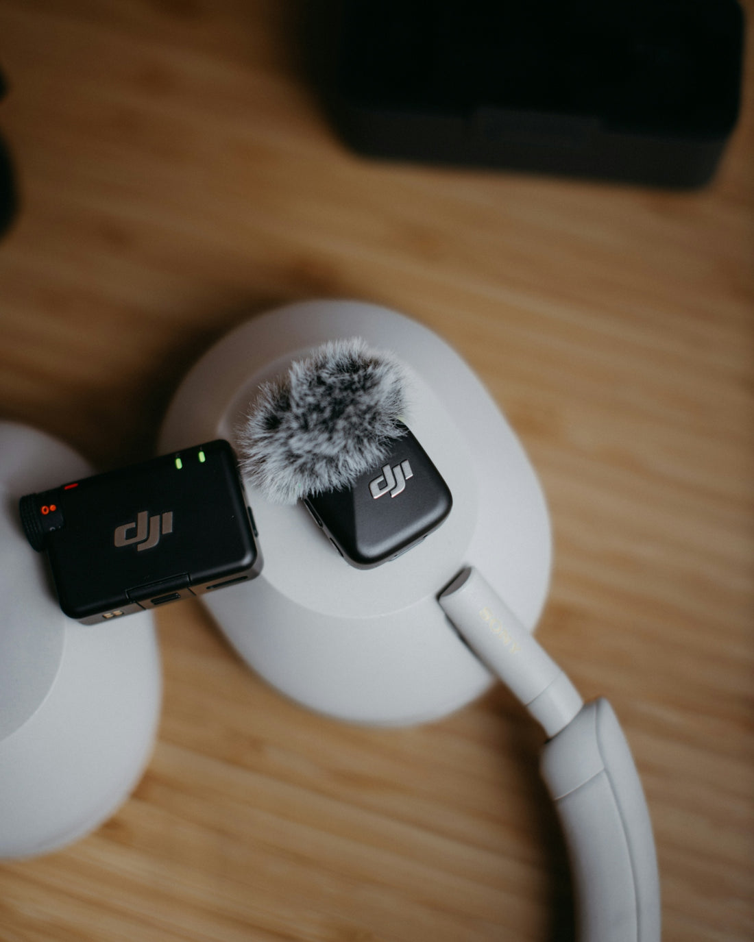 Dji wireless microphones on white headphones