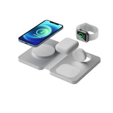 Wireless charging station with smartphone, smartwatch, and earbuds on a white background