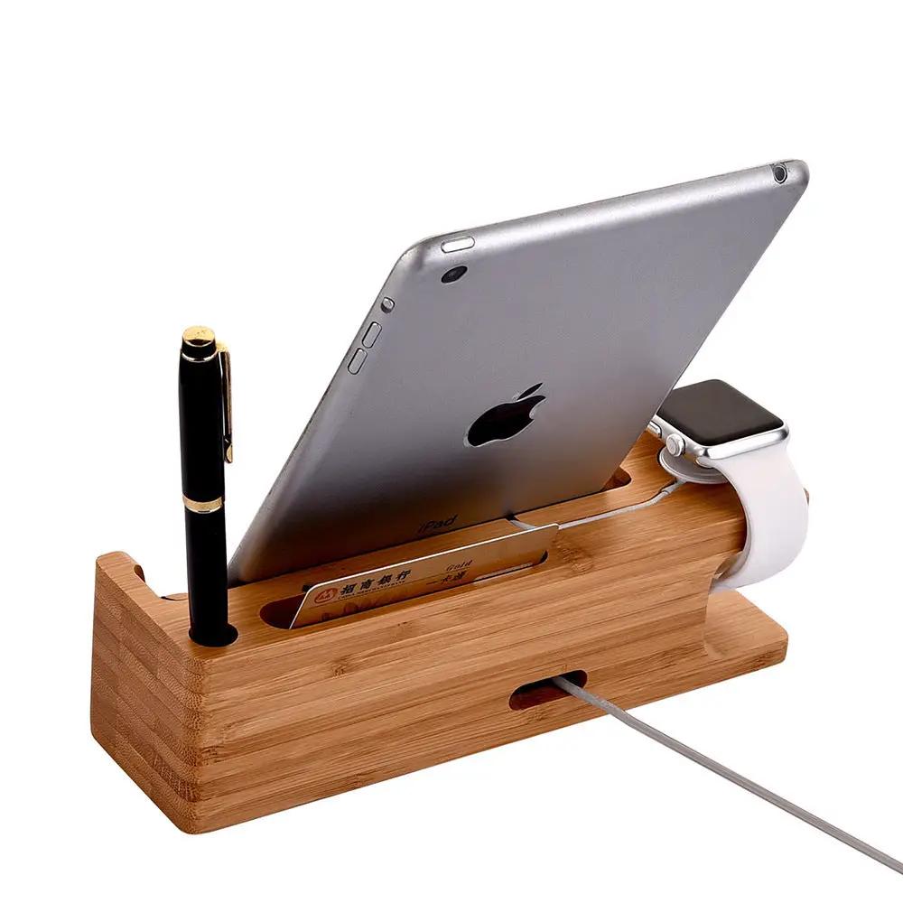 Wooden charging station with Apple products including an iPad, Apple Watch, and pen on a white background