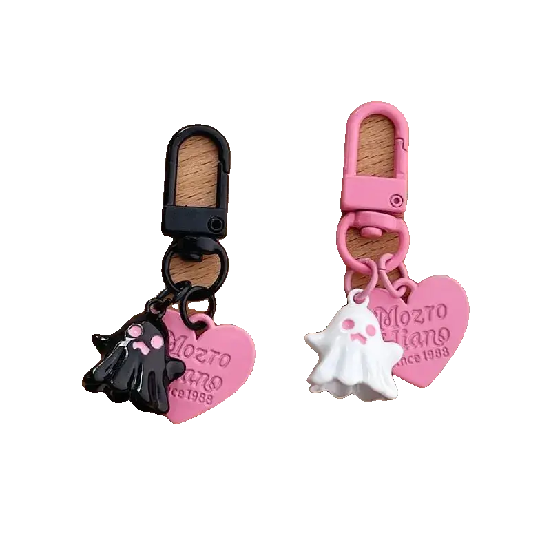 Two keychains, one black and one pink, with heart-shaped tags and a dog design on a white background.