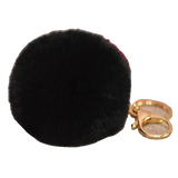 Black fluffy keychain with a gold clasp on a white background