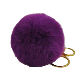 Purple fluffy keychain with gold ring on a white background
