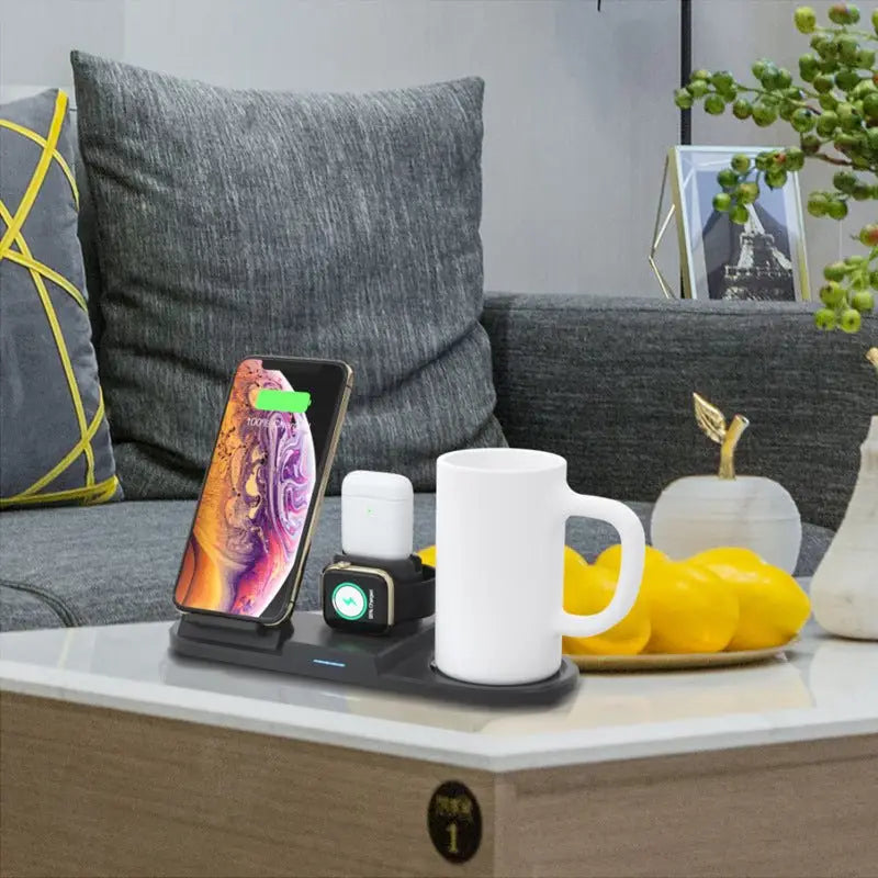Wireless charging station on a coffee table with phone, watch, and mug