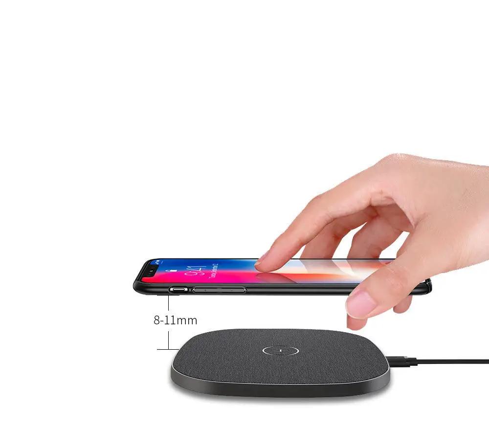 Wireless charging pad with a smartphone on a white background