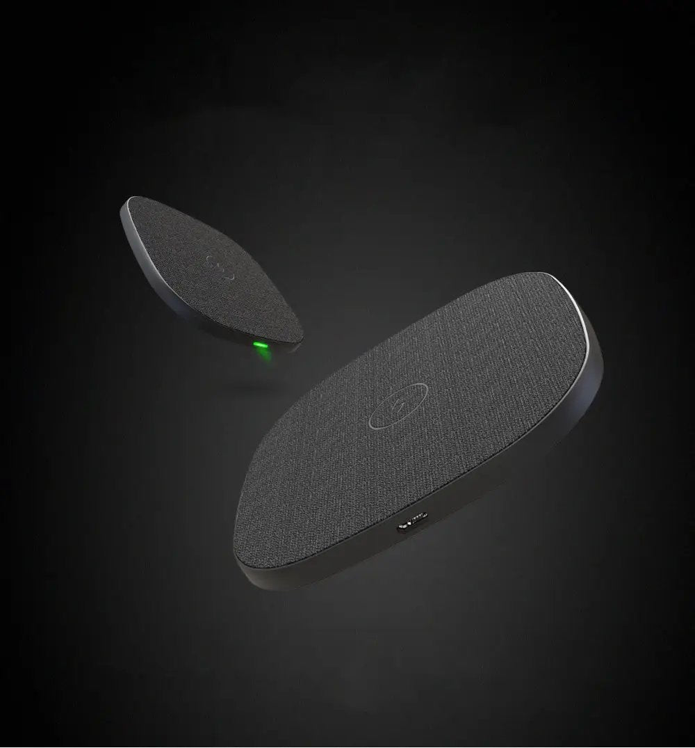 Wireless charging pad with a green light on a dark background