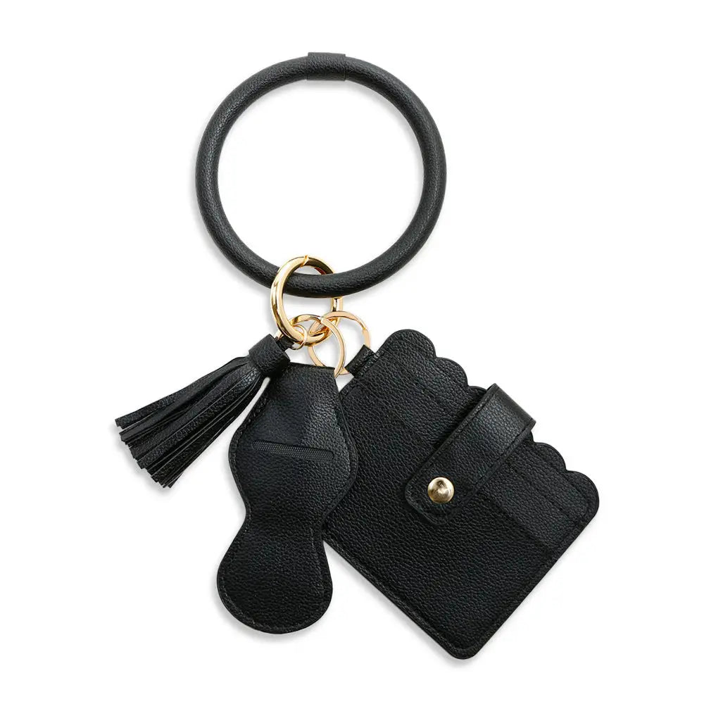 Black leather keychain with tassel and keyring on a white background