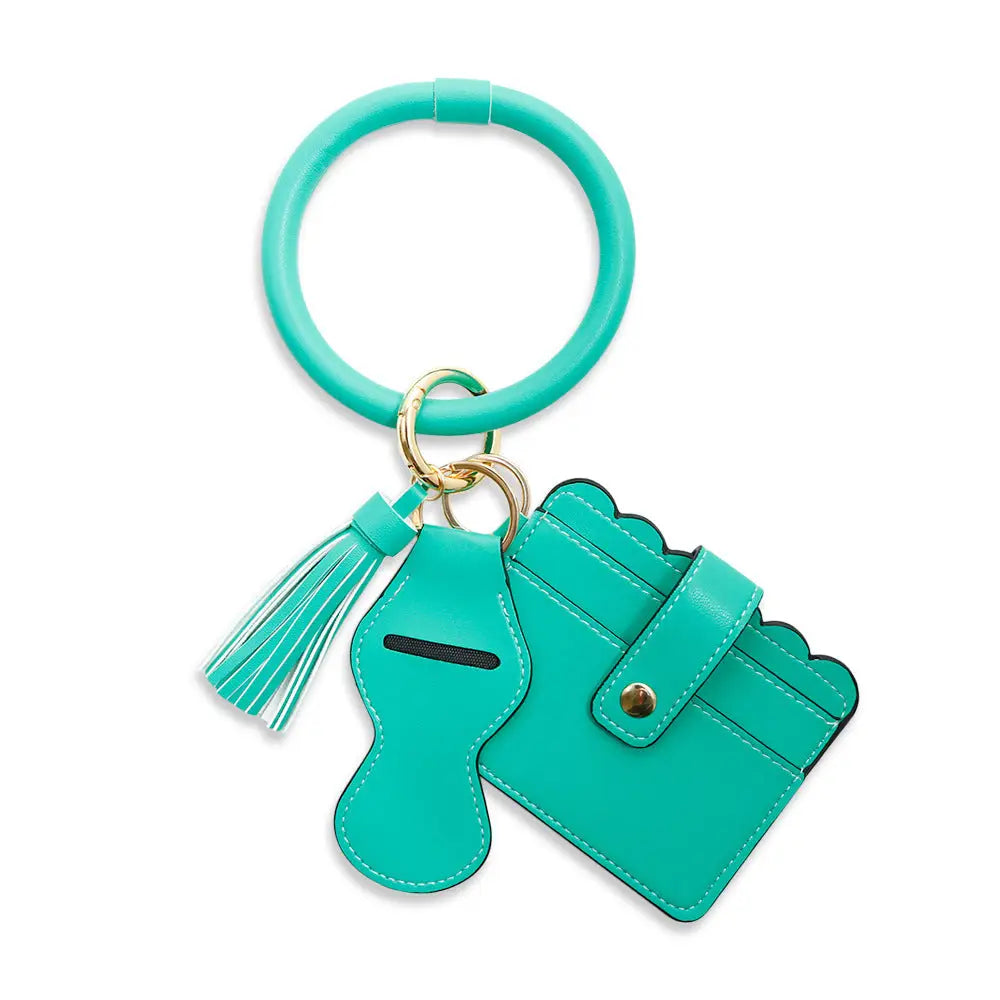 Turquoise keychain with card holder and tassel on a white background