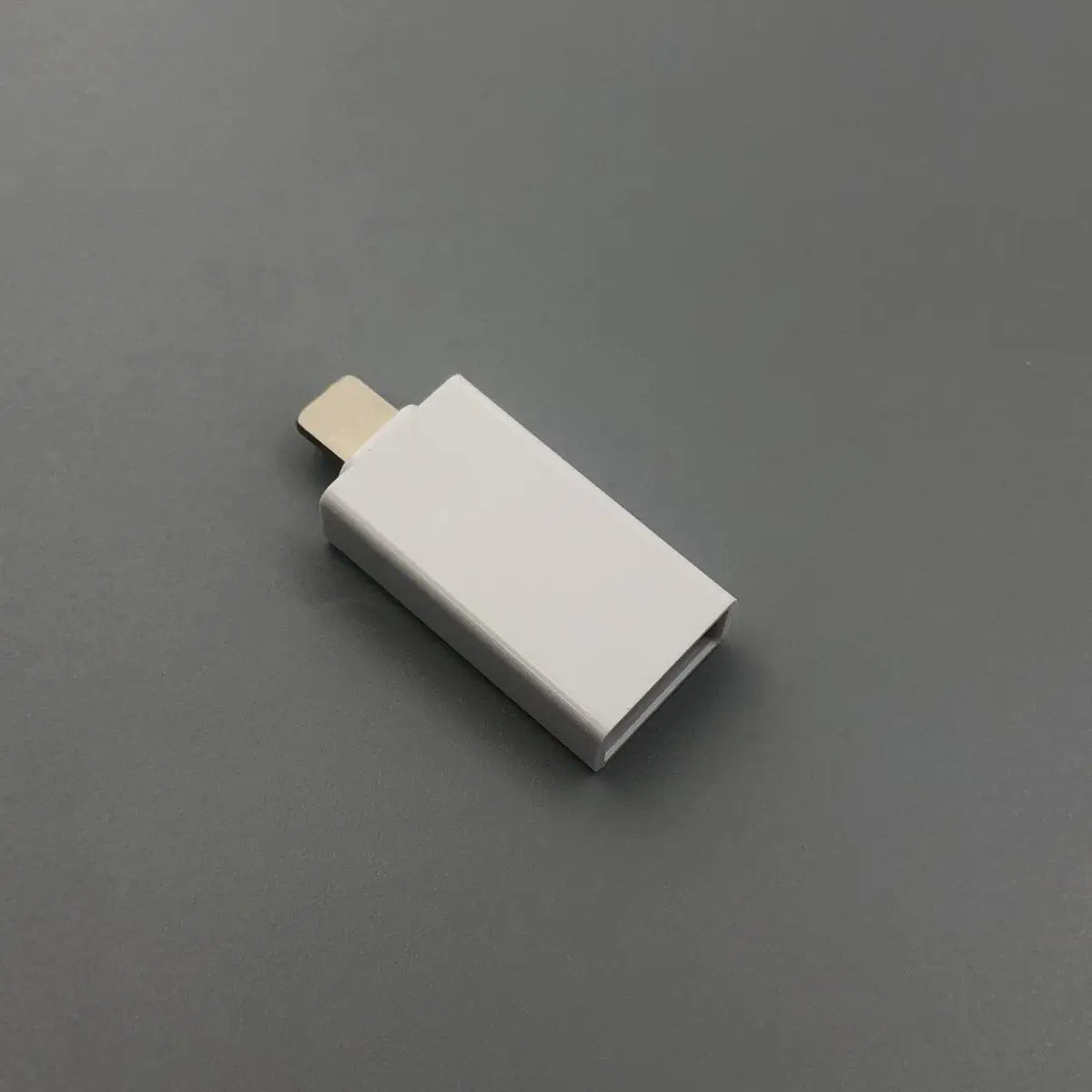 White USB drive on a gray background