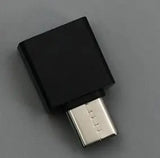 Black USB adapter on a gray background