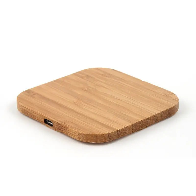 Wooden wireless charging pad on a white background
