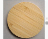 Round wooden cutting board on a gray surface