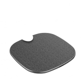 Person holding a gray wireless charging pad on a light wooden surface